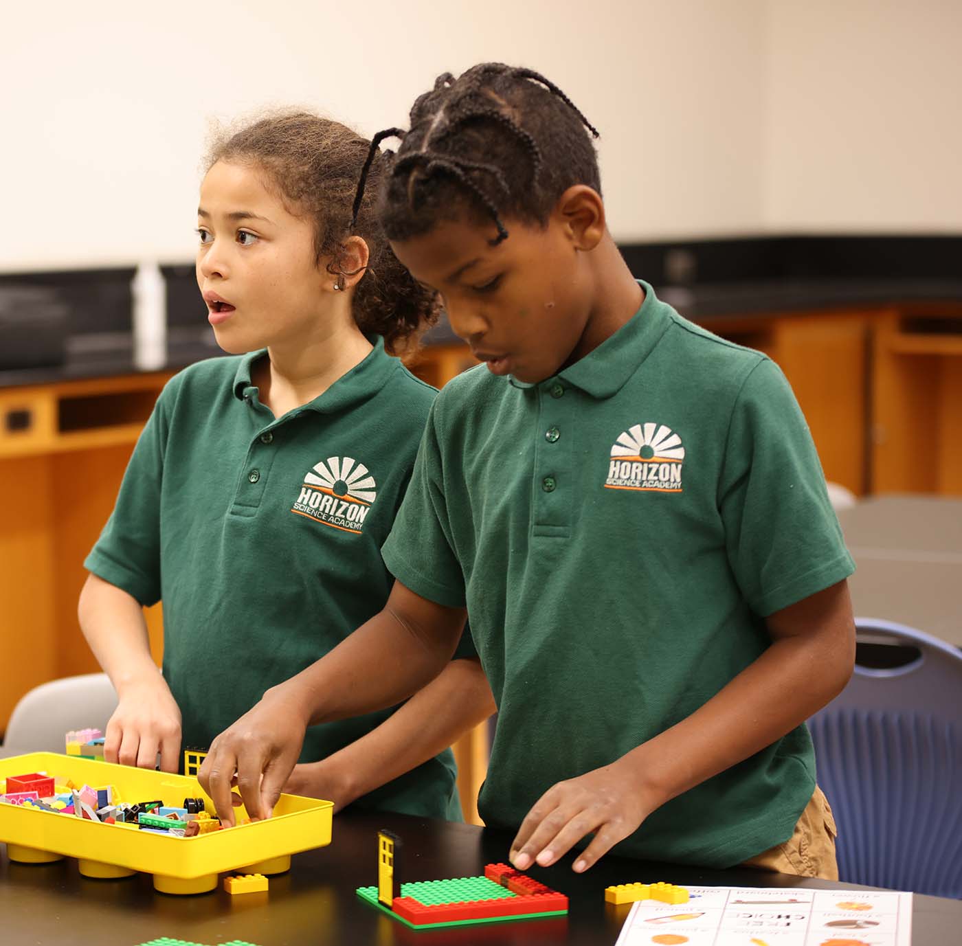 HSA Des Moines student drawing at a desk in a classroom setting