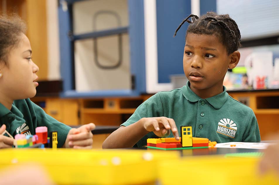 students and teacher working in classroom